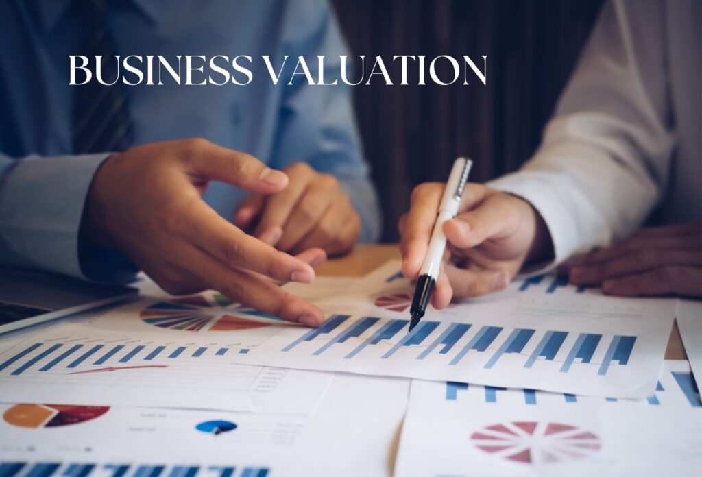 Two people reviewing graphs and charts for Ascend Business Brokers financial planning