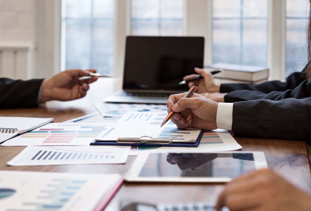 people reviewing graphs and charts for Ascend Business Brokers financial planning