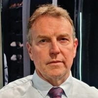 Greg Johnson, Principal Partner at Ascend Business Brokers, wearing shirt and tie, facing forward.