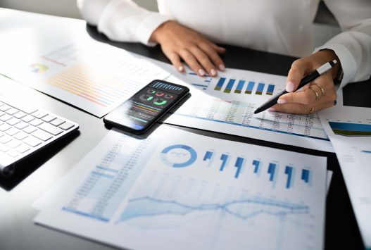 Ascend Business Brokers market comparison showing financial charts, graphs and data analysis on desk.