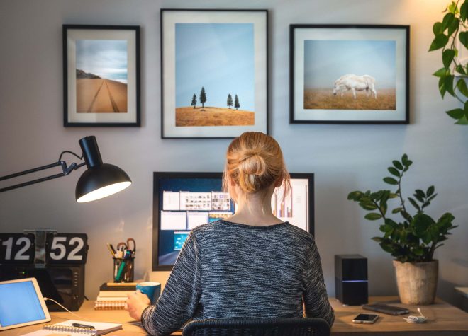 Home office setup with woman working at a computer listed by Ascend Business Brokers